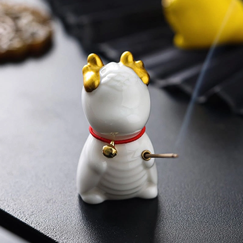 White dragon ceramic incense holder rear side view with incense stick inserted and subtle smoke wisps