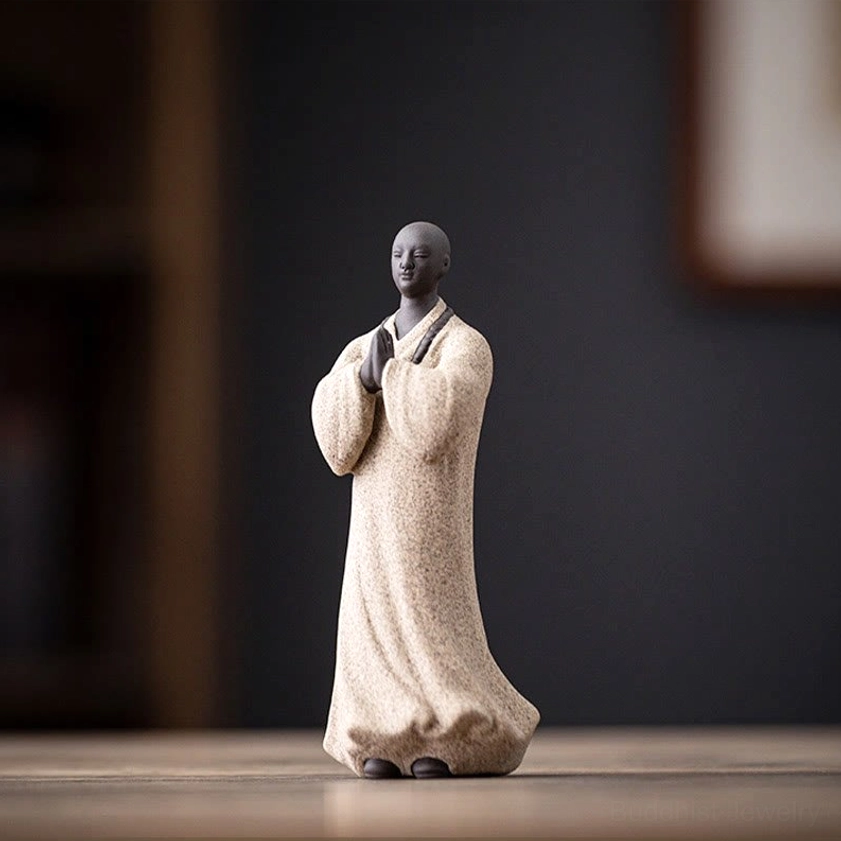 White ceramic meditation monk statue with matte finish and detailed prayer bead necklace for mindfulness practice