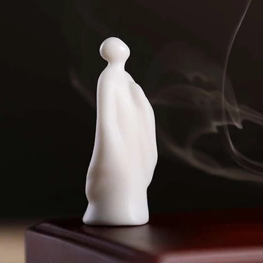 White ceramic zen monk figurine meditation statue with incense smoke
