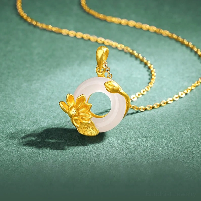 White chalcedony lotus peace buckle pendant necklace with gold lotus ornament and fine sterling silver chain on dark green background