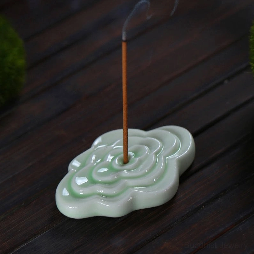 White ceramic cloud incense burner displaying matte finish glaze, embossed auspicious cloud pattern, and meditation-space aesthetic for spiritual practice