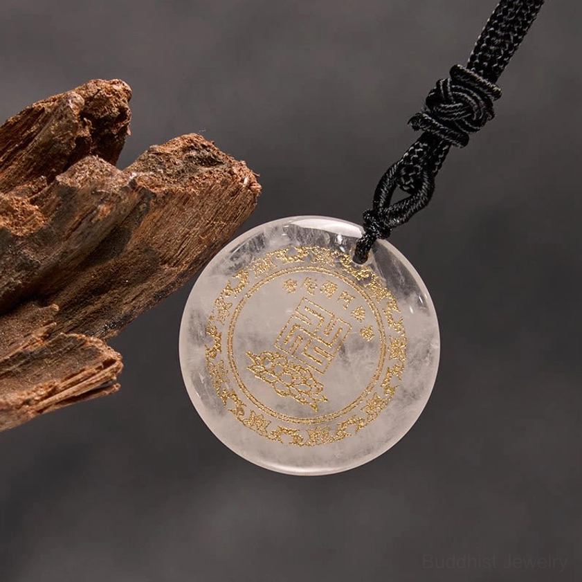 Clear quartz Buddhist meditation pendant oblique side angle on wooden surface with necklace cord
