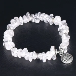 White crystal lotus bracelet top-down full view with silver engraved lotus charm pendant