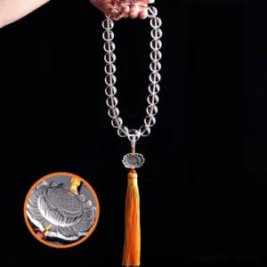 White crystal lotus mala bracelet with carved lotus pendant and yellow tassel, close-up detail shot