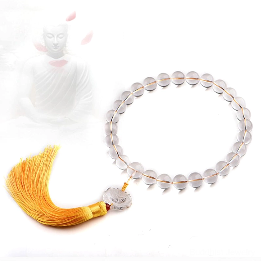 Single-loop clear crystal meditation mala bracelet with lotus pendant, flat lay on light background
