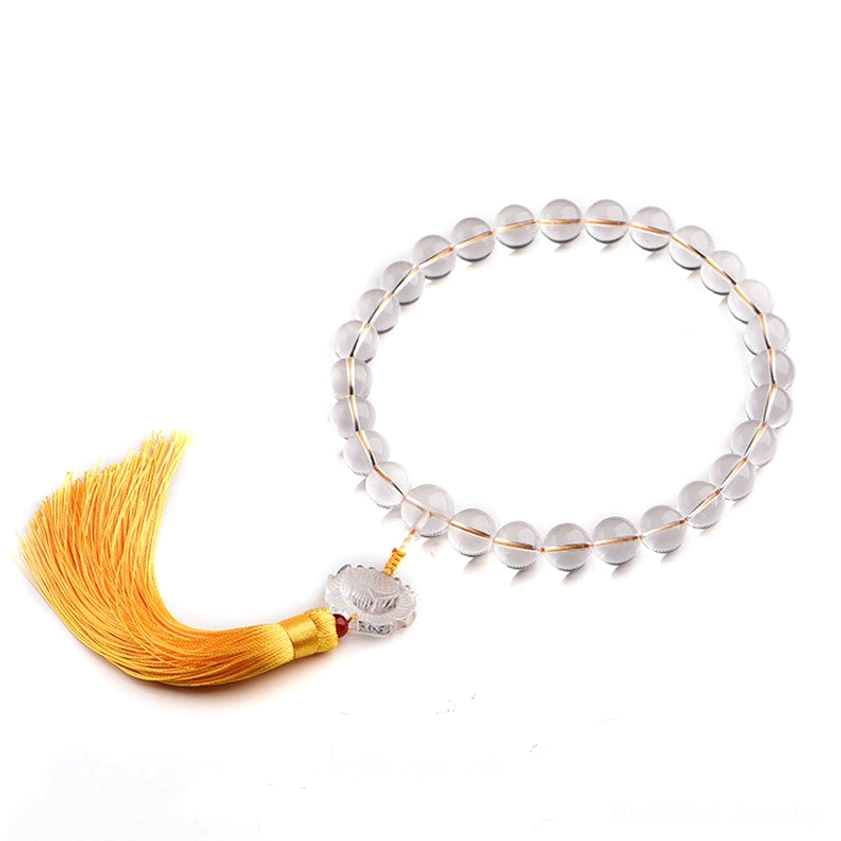 White crystal mala bracelet with smooth polished quartz beads and lotus charm on light background