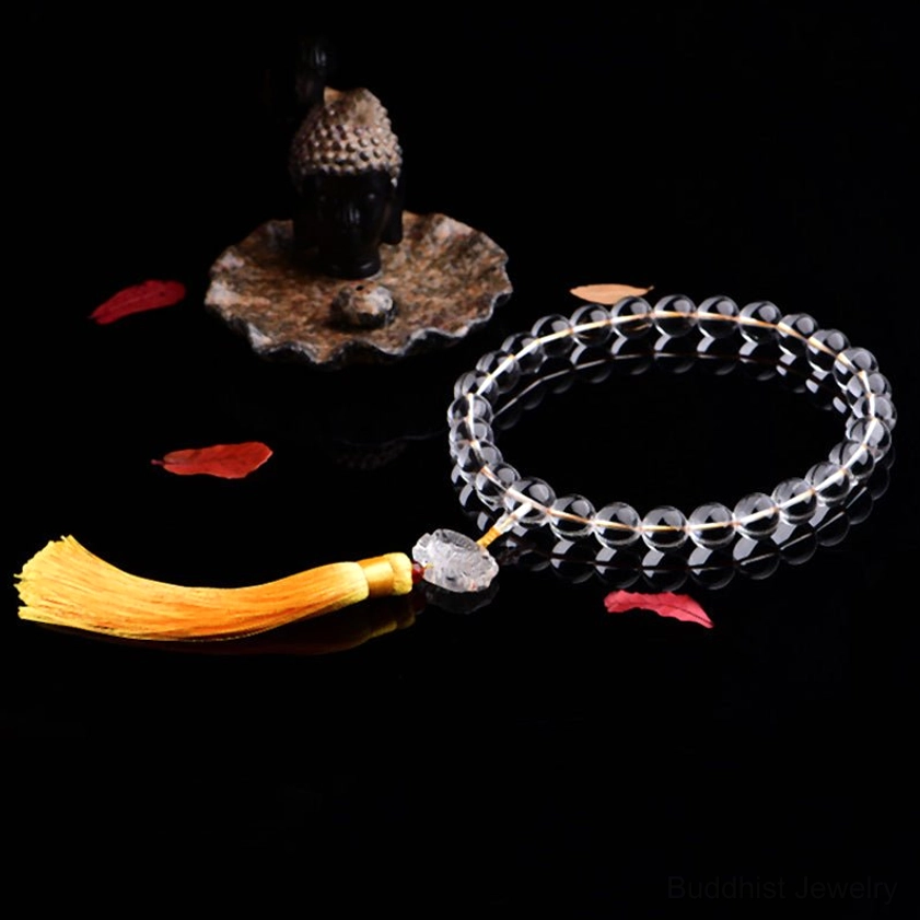 Double-loop white crystal mala bracelet with carved lotus charm, red spacer bead and yellow tassel