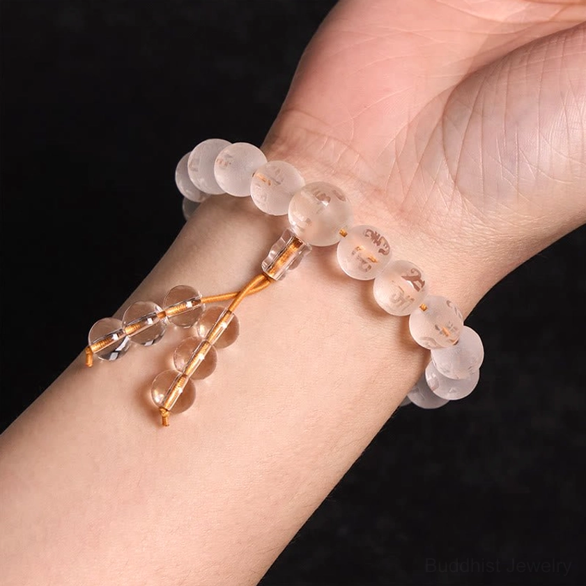 White crystal Buddhist meditation bracelet worn on left human wrist showing tassel hanging design and comfortable fit for daily wear
