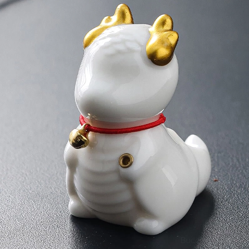 White ceramic dragon bell incense burner front three-quarter view with pure white glaze and golden accents