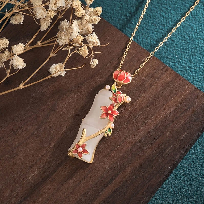 White jade bamboo lotus pendant right-front angle showcasing delicate red flower buds and gold decorative elements, Buddhist enlightenment necklace