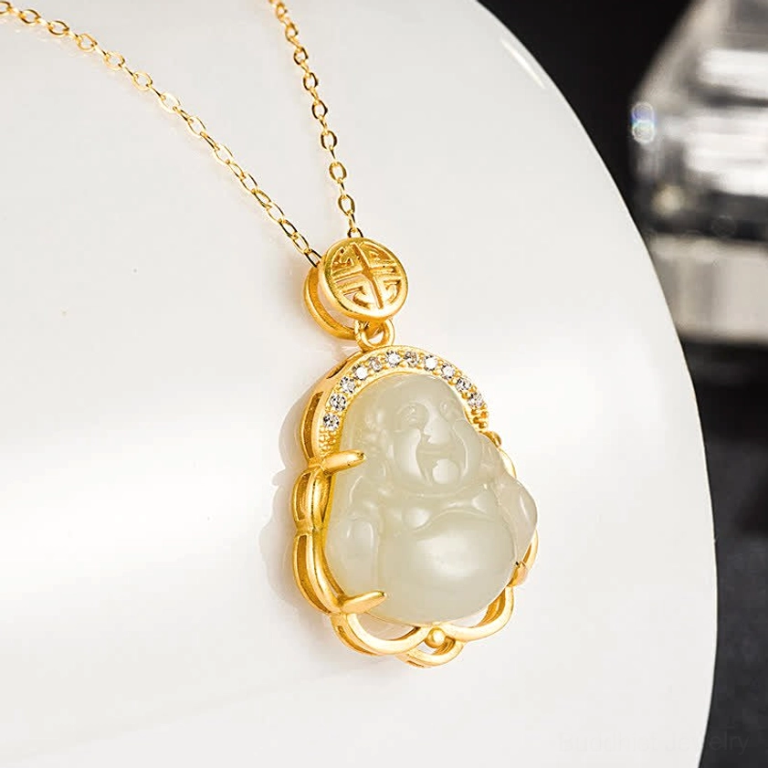 Premium Hetian white jade Buddha charm pendant displayed on white ceramic surface, showcasing smooth polished jade texture and silver metal frame detail