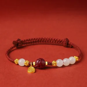 24K gold plated white jade cinnabar lotus bracelet with red adjustable string, front view showing beads and gold lotus pendant
