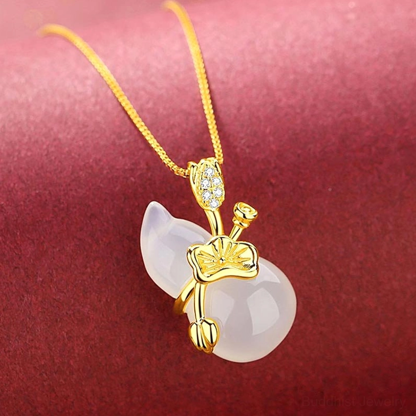 White chalcedony jade gourd pendant necklace side angle, slim gold chain with lotus metal details on red background