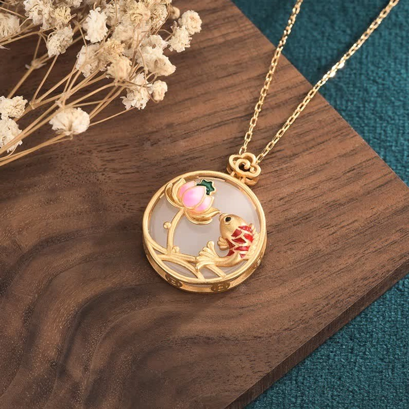 Buddhist jade pendant showing pink enamel lotus and red white koi fish detail with gold frame