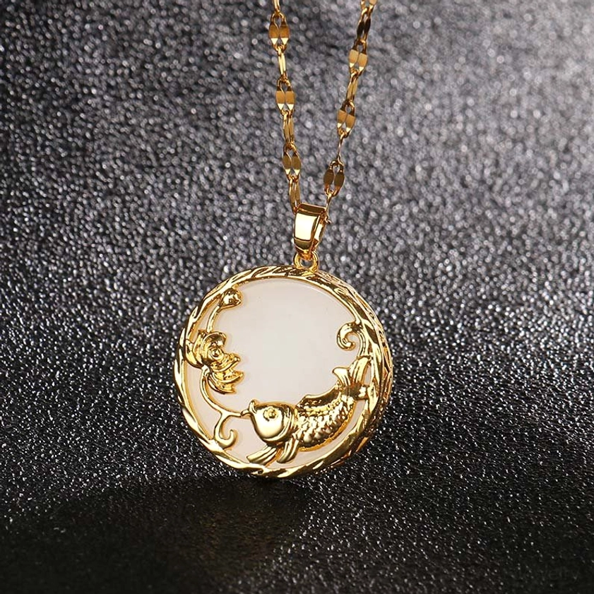 White jade koi fish lotus necklace pendant with gold embossed design close-up on frosted background
