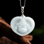 Heart-shaped white jade laughing Buddha pendant necklace with titanium steel chain, front view showing carved Buddha figure