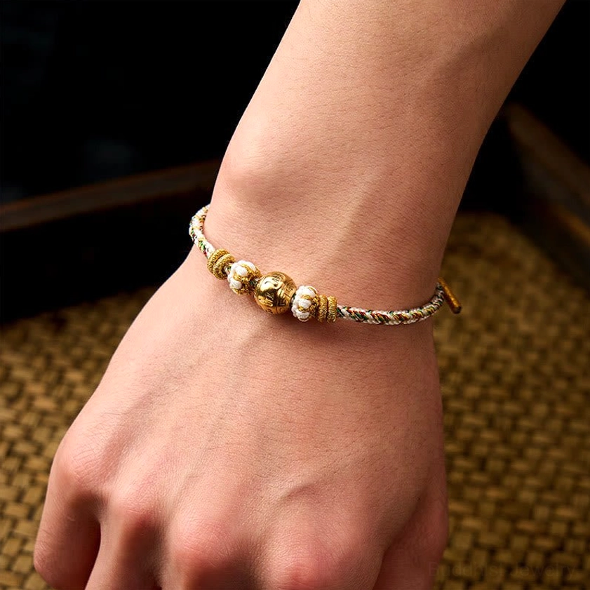 White Om Mani Padme Hum bracelet worn on wrist showing slim fit and comfortable adjustable cord closure
