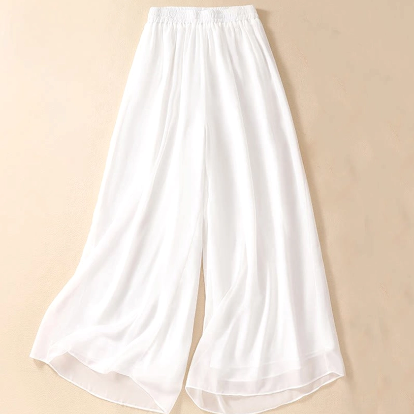 Full-length view of white meditation pants with wide leg silhouette and relaxed fit design