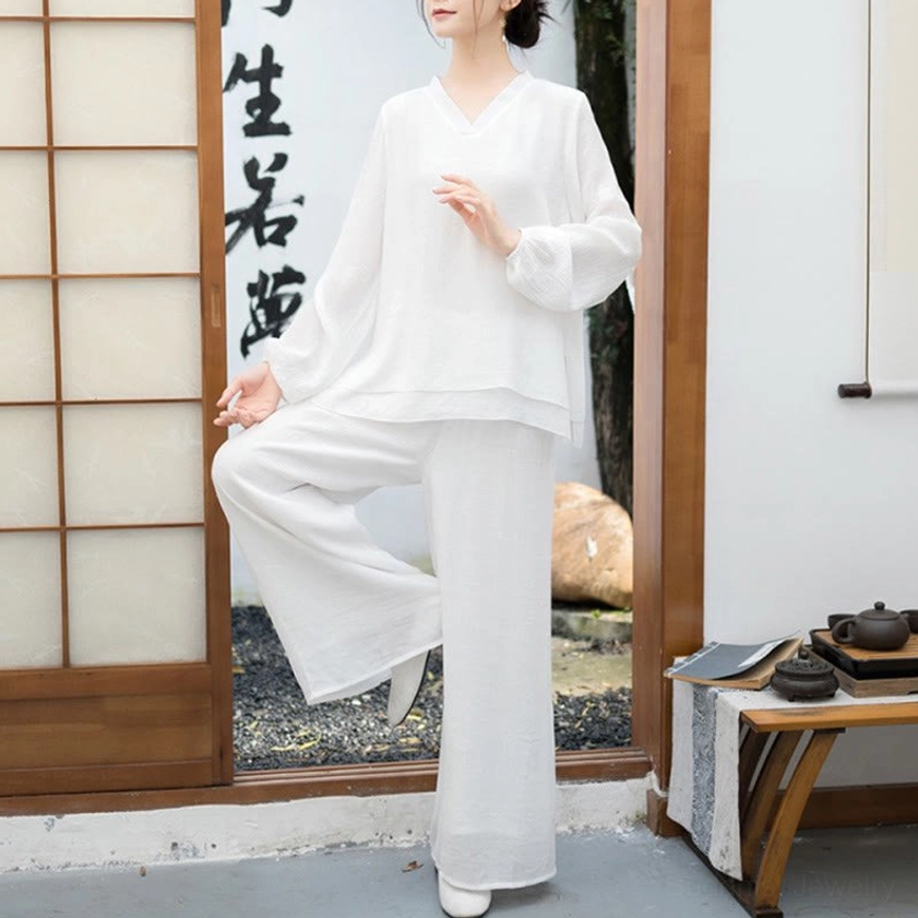 White meditation two-piece set front view showing V-neck top with long lantern sleeves and wide-leg pants