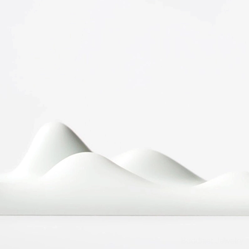 Pure white mountain peak incense holder close-up showing undulating ceramic peaks detail