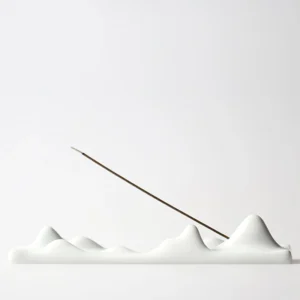 White ceramic mountain peak incense holder with multi-peak design, front view on white background