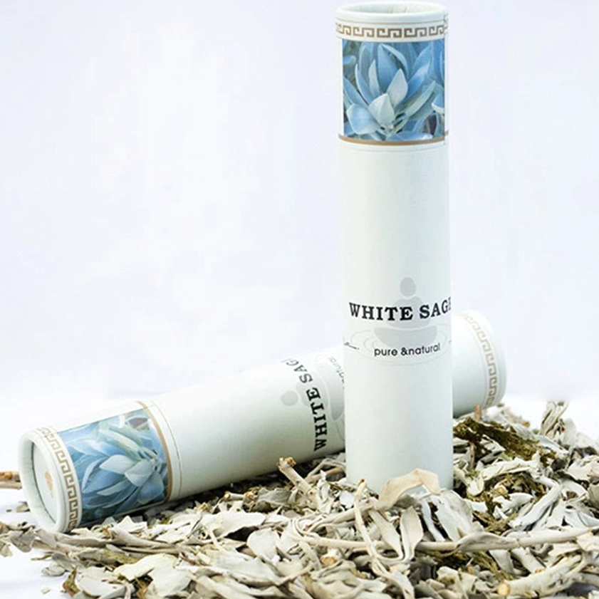 Complete white sage incense set display with natural paper packaging and dried sage botanicals studio background