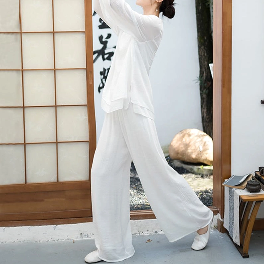 Woman in white spiritual meditation attire walking in Japanese entryway