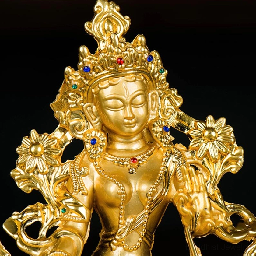 Close-up detail of White Tara Buddha statue face showing intricate facial features and gem-studded crown ornaments