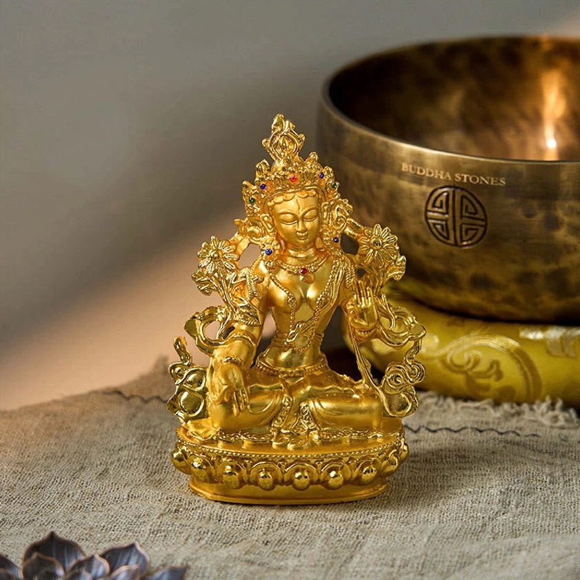 Handcrafted White Tara statue with singing bowl, showcasing intricate gilded metalwork and religious adornments