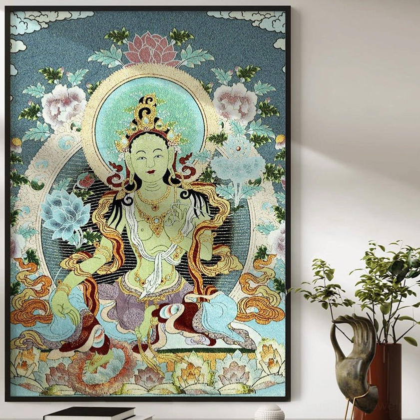 White Tara embroidered thangka tapestry framed and displayed on living room wall with potted plant home sanctuary