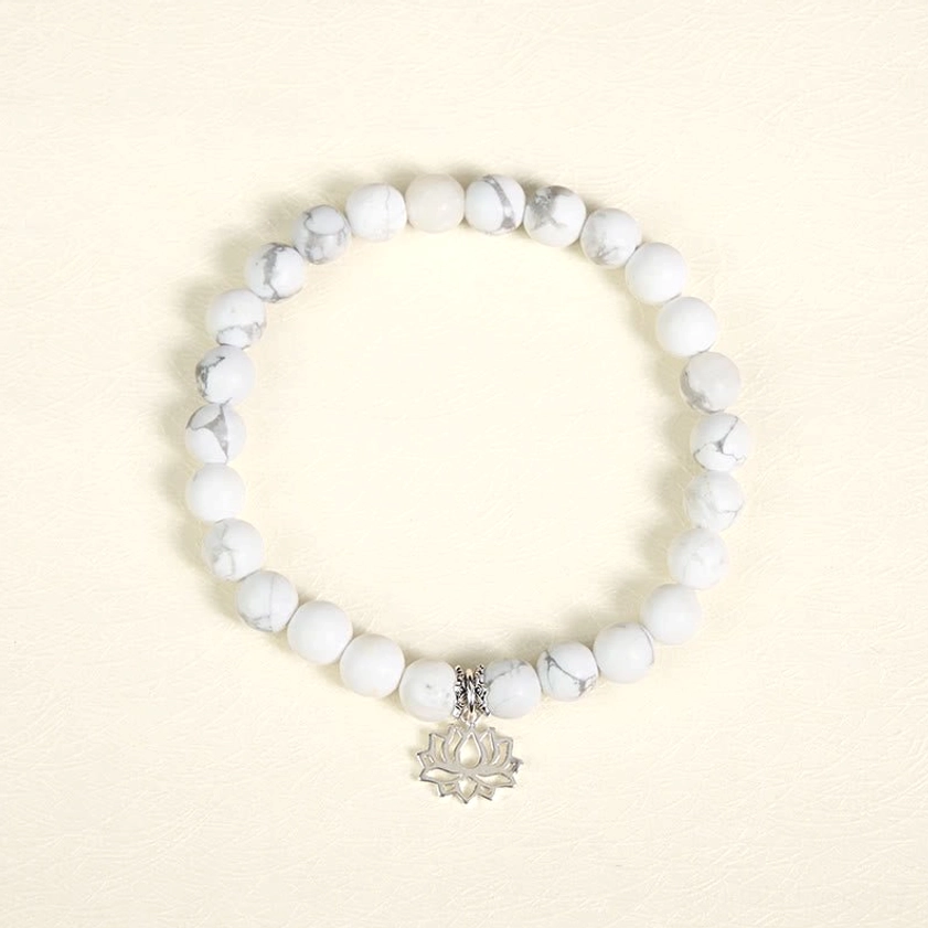 Full circle view of stretch white turquoise lotus sterling silver bracelet showing complete bead arrangement and silver charm