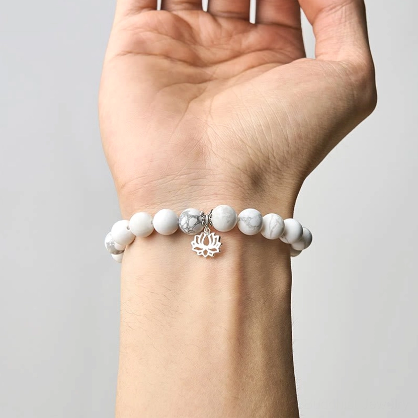 Multiple white turquoise lotus bracelets in different sizes showing variety of 6mm and 8mm bead options