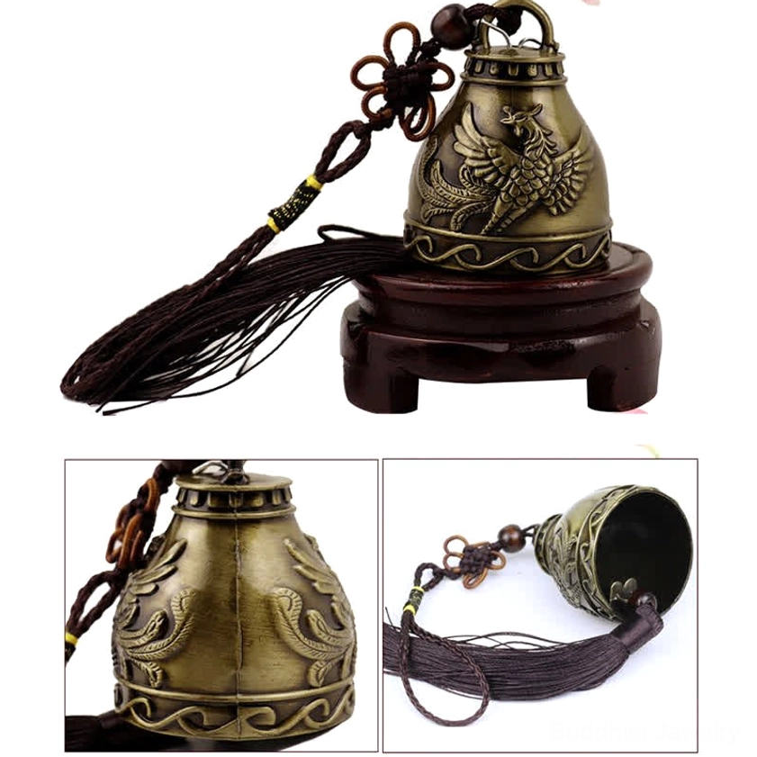 Close-up of bronze wind chime bell showing embossed swirling patterns and aged metal texture