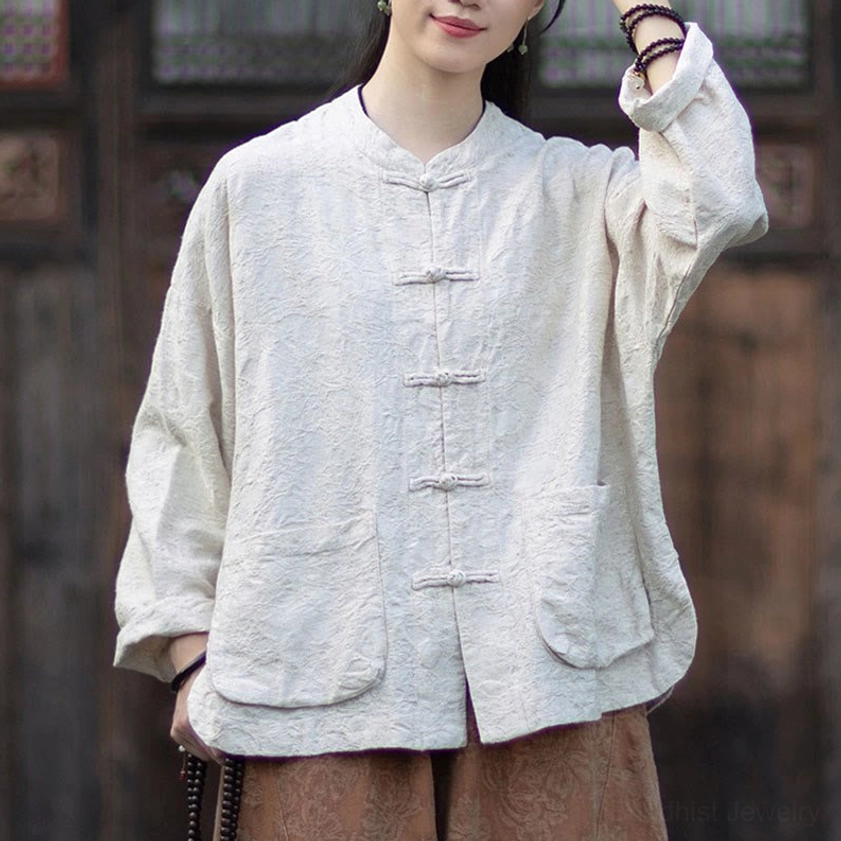 Women's beige jacquard meditation shirt with frog buttons in vintage courtyard setting