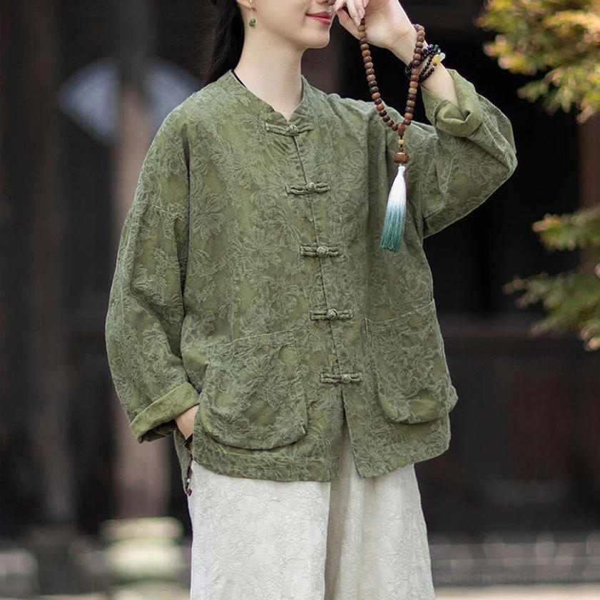 Three-quarter view of women's jacquard meditation shirt with stand collar, frog closures, and prayer beads