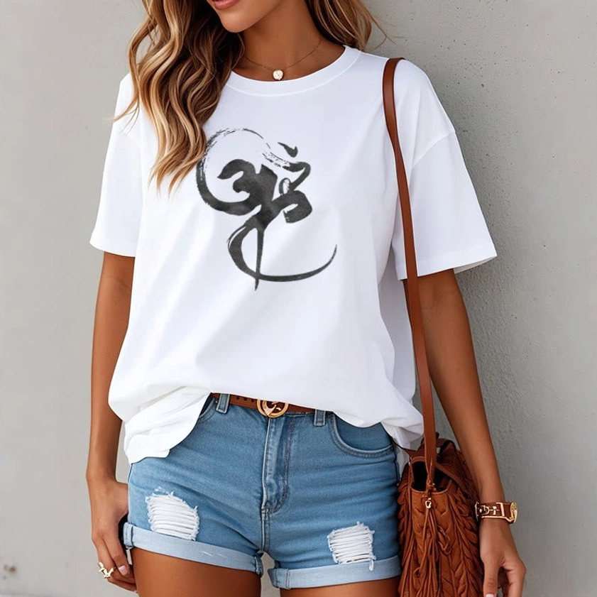 Woman wearing white Om spiritual t-shirt with denim shorts brown bag casual outfit inspiration