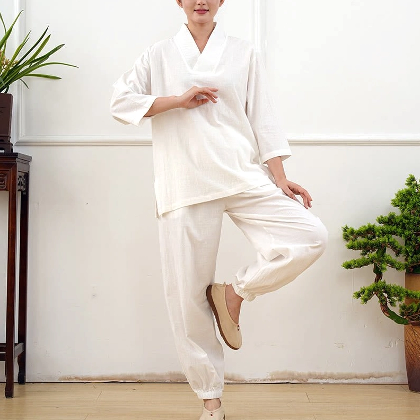 Women in gray three-quarter sleeve meditation clothing demonstrating tai chi movement sequence