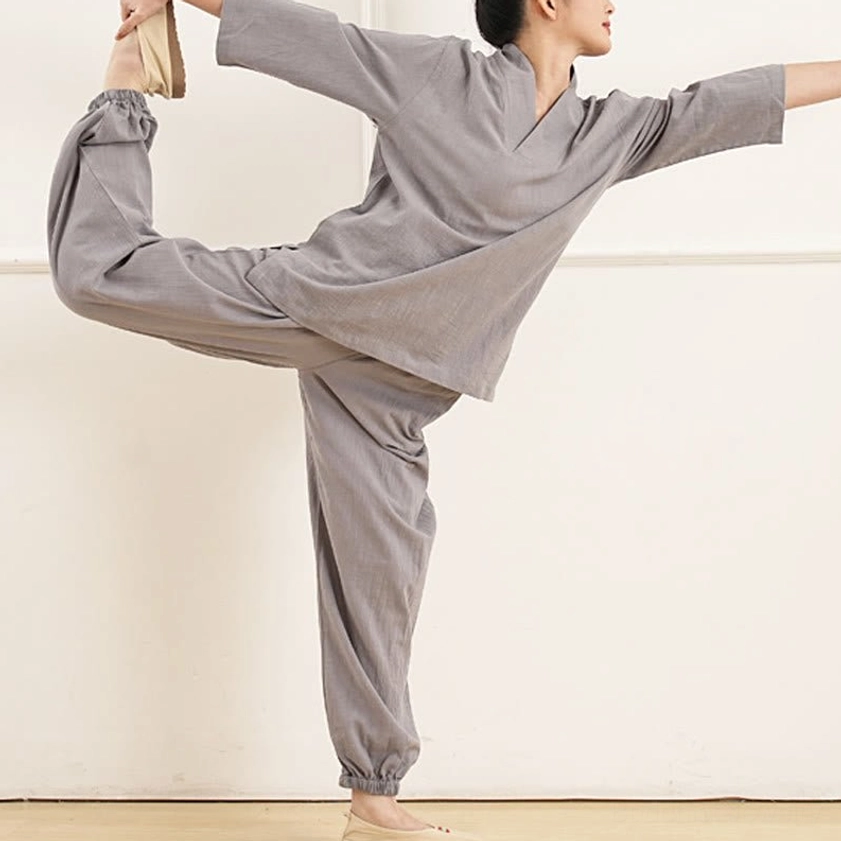 Side view of women wearing gray yoga tai chi practice suit in dynamic movement