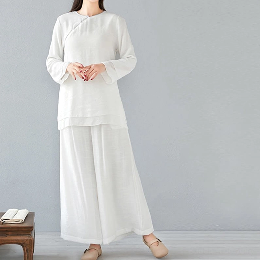 Model in white long-sleeve cotton linen meditation outfit with relaxed wide-leg pants, front full-body studio view
