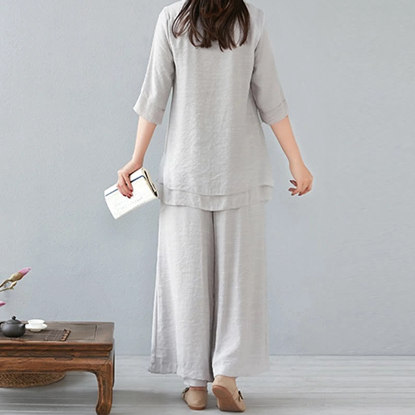 Back full-length view of woman wearing white meditation cotton linen long-sleeve set with natural drape and wide-leg silhouette