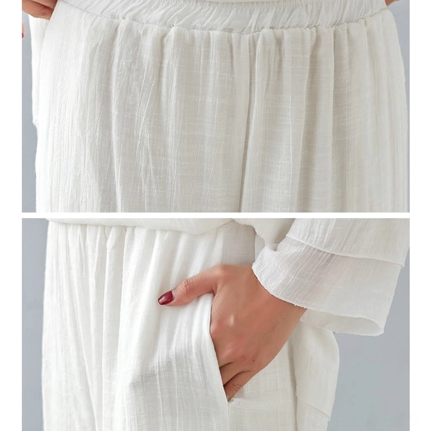 Woman in white meditation cotton linen long-sleeve top and wide-leg pants detail shot showing natural fabric drape and comfort fit