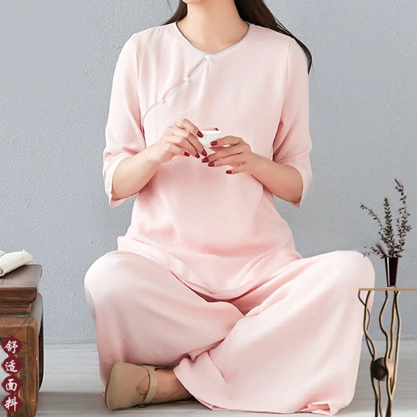 Woman in white long-sleeve meditation cotton linen outfit standing in neutral pose showing relaxed fit and comfortable silhouette