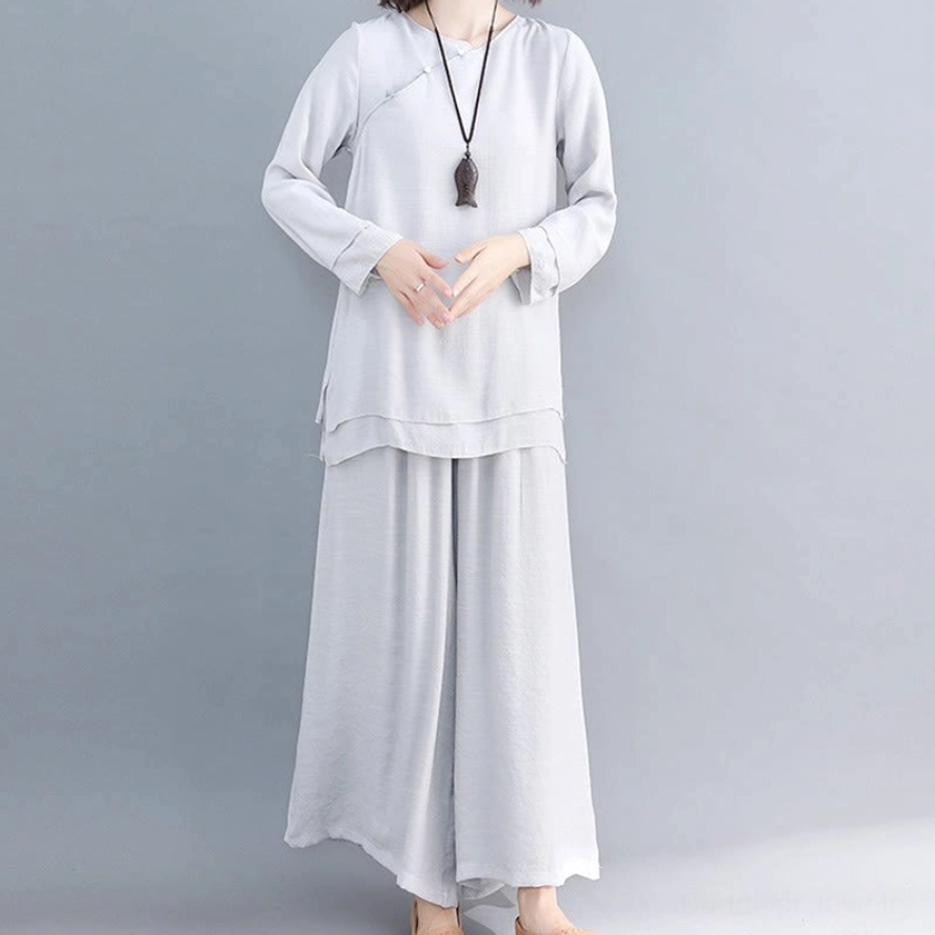 Woman wearing pure white long-sleeve meditation cotton linen top with relaxed wide-leg pants, front full-body studio view