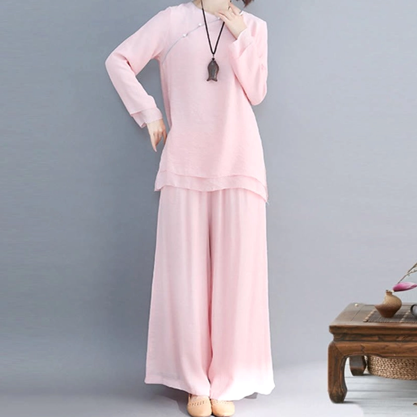 Full-body front view of model wearing white three-quarter sleeve meditation linen top with elastic waistband wide-leg pants