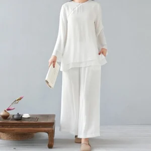 Women wearing pure white three-quarter sleeve meditation cotton linen top with loose wide-leg pants, front full-body view in Chinese-style tea room