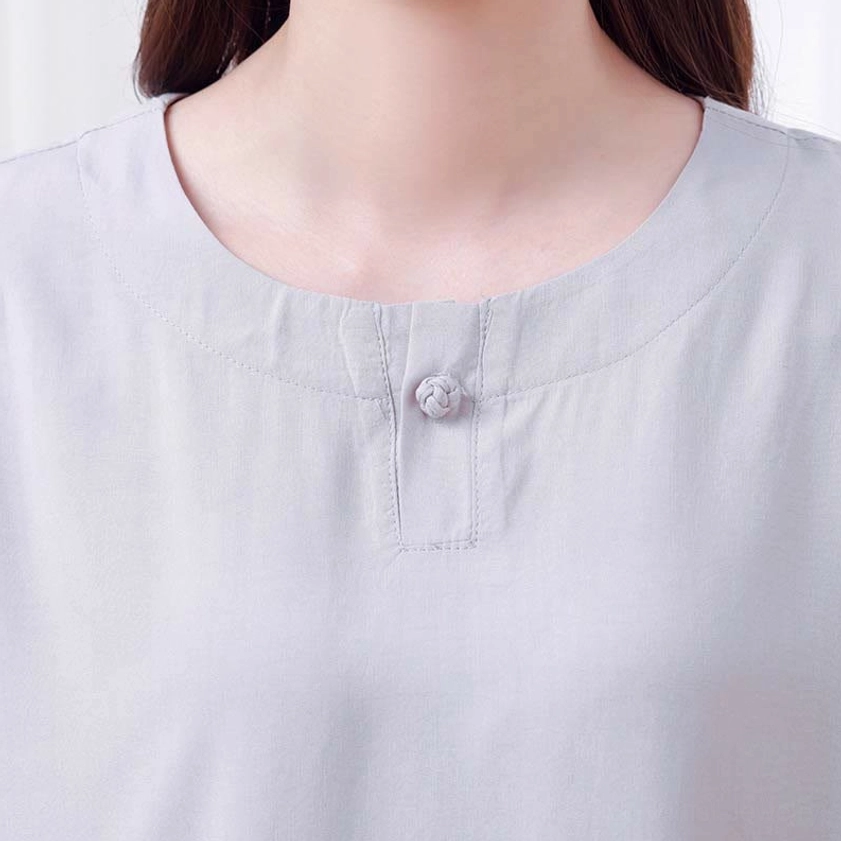 Navy women's meditation clothing set detail view showing frog button closure and crew neckline