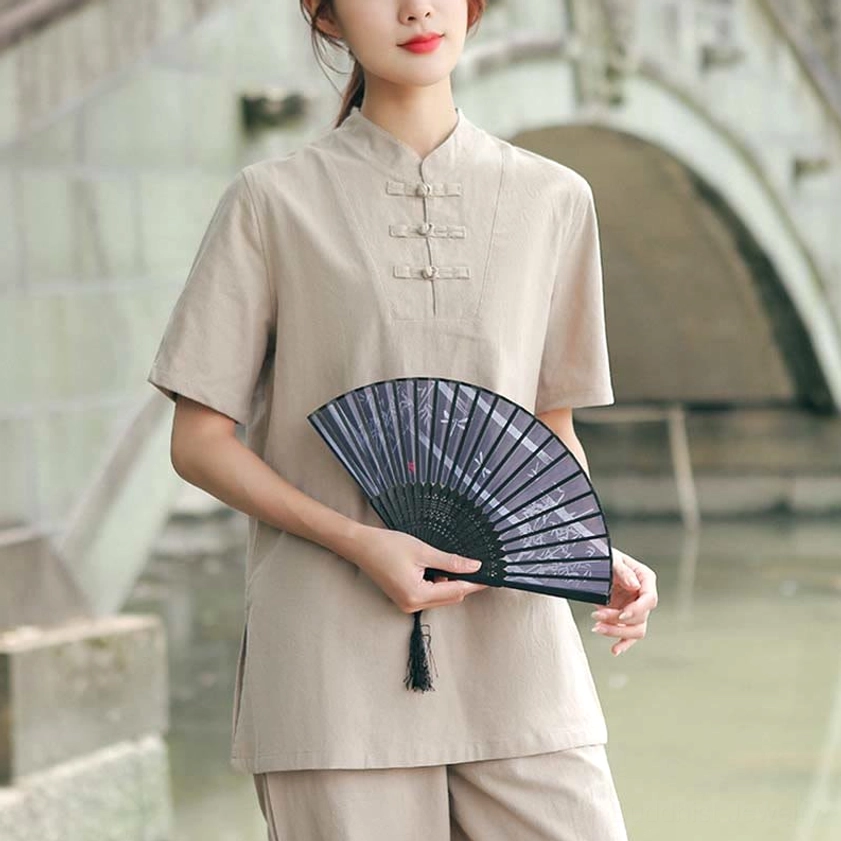 Women's khaki cotton-linen meditation and tai chi clothing set with stand collar, front full-body view in traditional garden setting