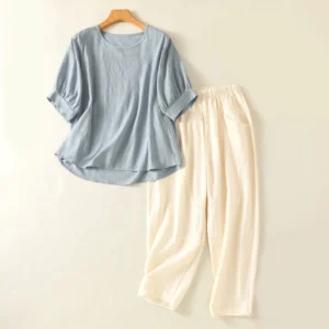 Women's meditation yoga set in light sky blue cotton - complete two-piece spiritual practice clothing laid flat