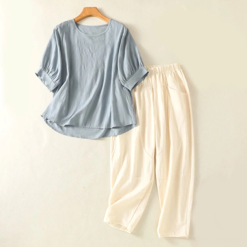 Women's meditation yoga set in light sky blue cotton - complete two-piece spiritual practice clothing laid flat