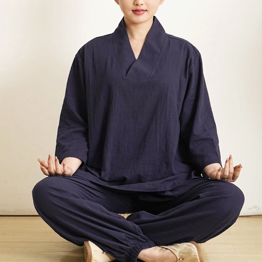 Women wearing navy blue cotton tai chi meditation clothing set in meditation pose, front eye-level view